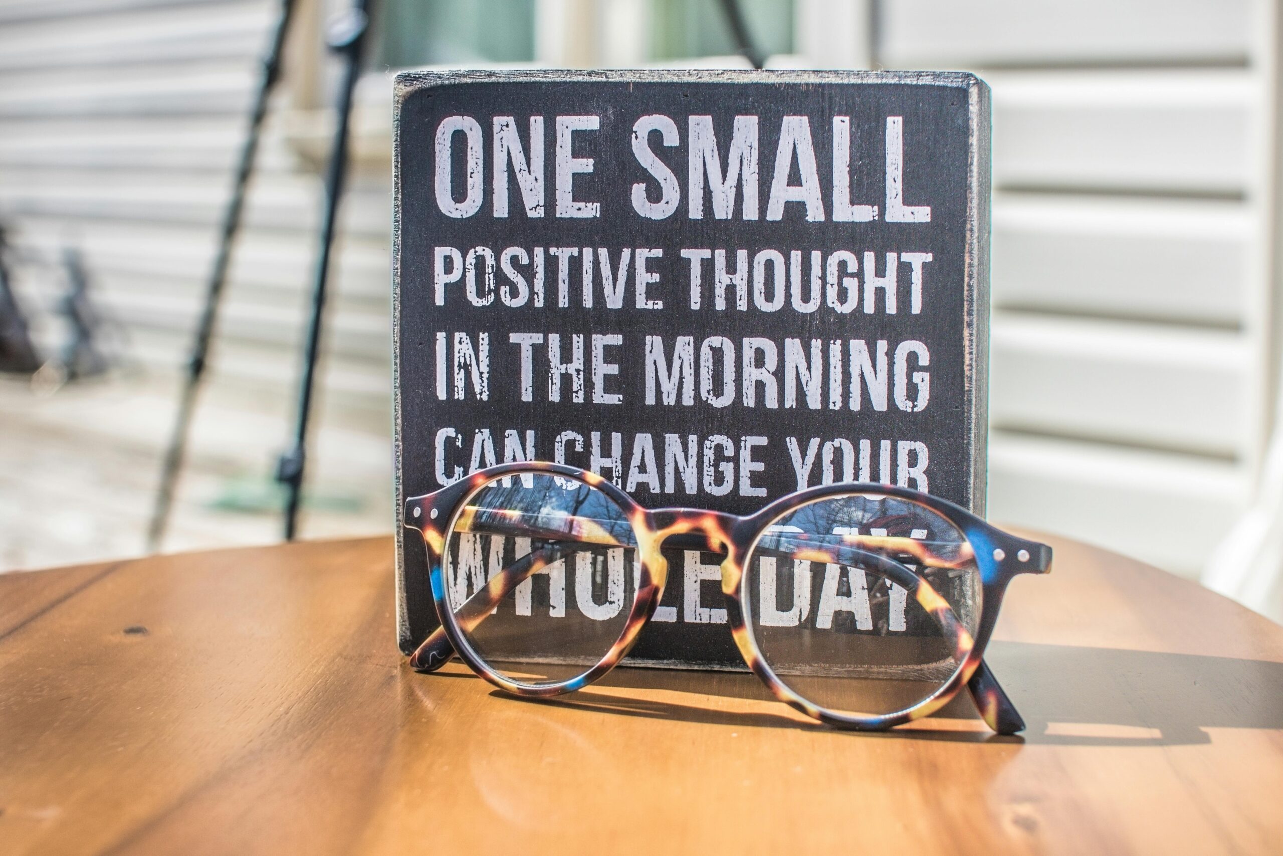 Photo by Binti Malu: https://www.pexels.com/photo/photo-of-a-sign-and-eyeglasses-on-table-1485657/ Cultivating a Positive Mindset